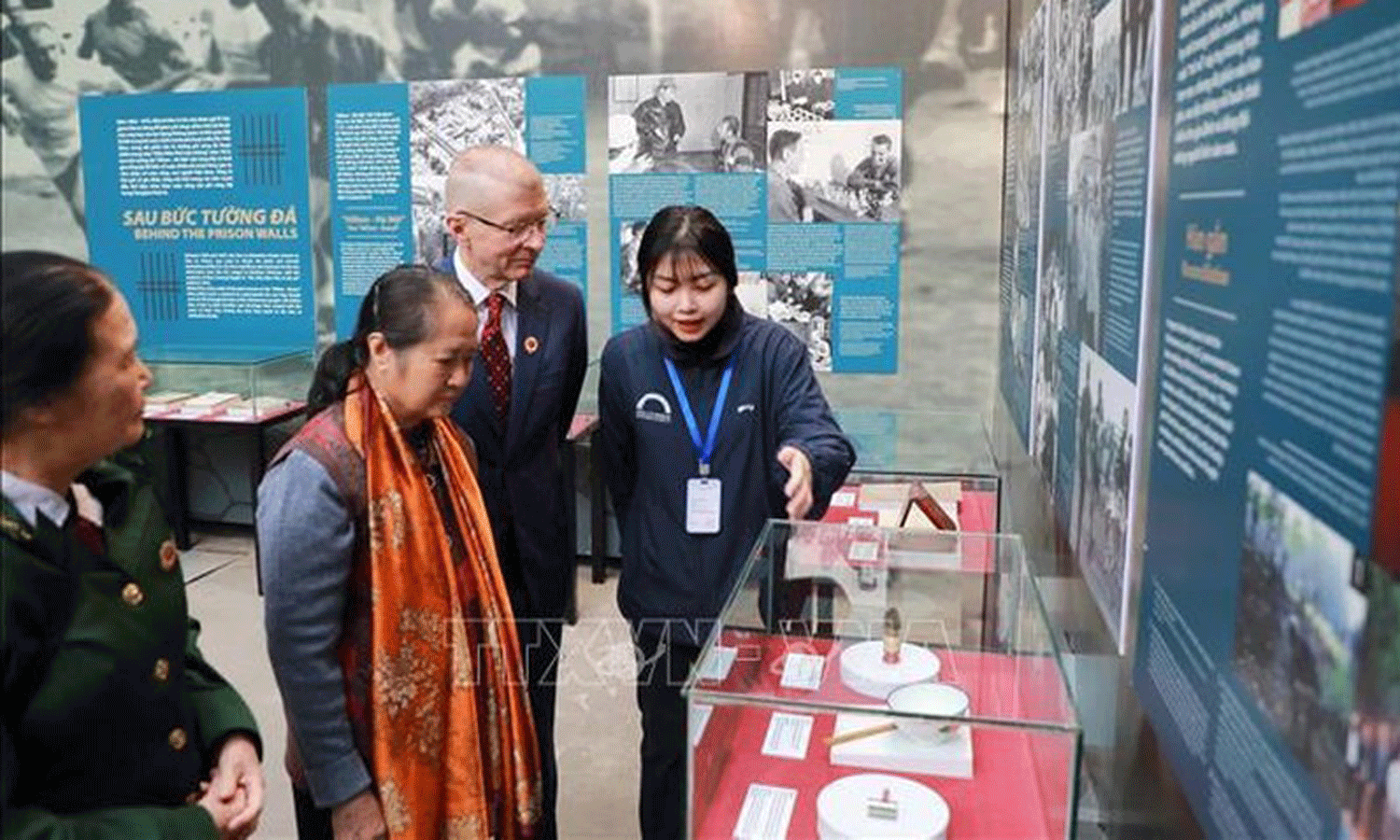 Visitors to the exhibition that opened at the Hoa Lo Prison relic site on December 9. (Photo: VNA).