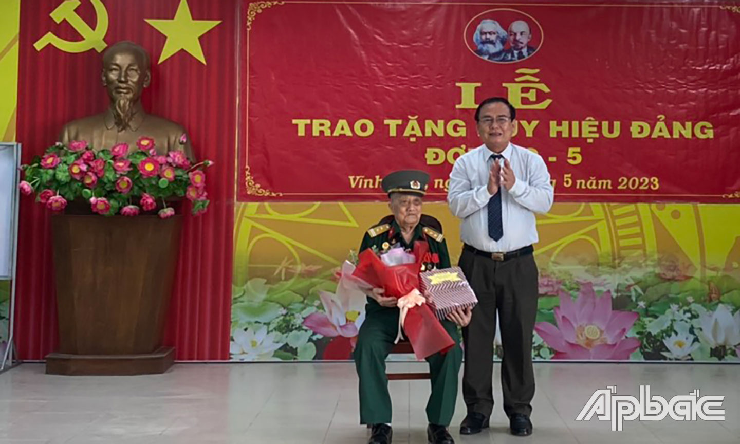 Đồng chí Võ Văn Bình trao Huy hiệu 75 năm tuổi Đảng cho đồng chí Nguyễn Tấn Lập.