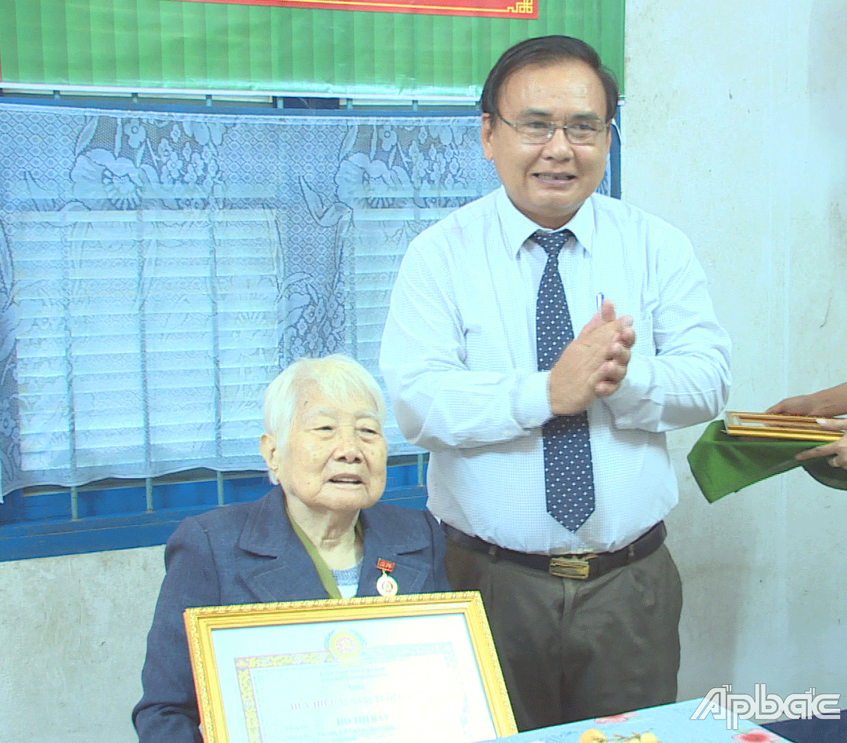 đồng chí Võ Văn Bình đến tận nhà và trao Huy hiệu Đảng 75 năm tuổi Đảng cho đảng viên Hồ Thị Bảy thuộc Đảng bộ xã Mỹ Phong.