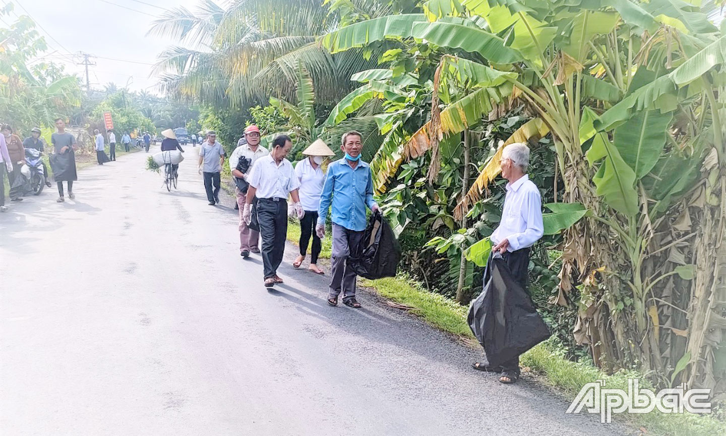 Hội viên CCB và nhân dân xã Hòa Định tham gia thu gom rác thải trên các tuyến đường của xã.