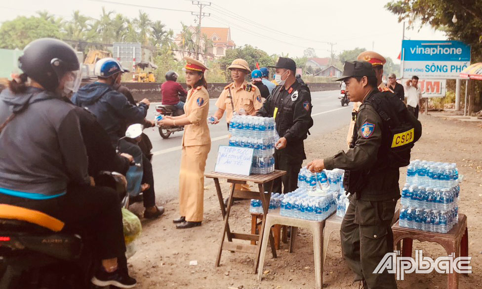 Trạm Cảnh sát giao thông Trung Lương - Phòng Cảnh sát giao thông phát nước suối miễn phí cho người dân về quê ăn tết trên tuyến Quốc lộ 1 (đoạn qua TT. Bình Phú, huyện Cai Lậy).