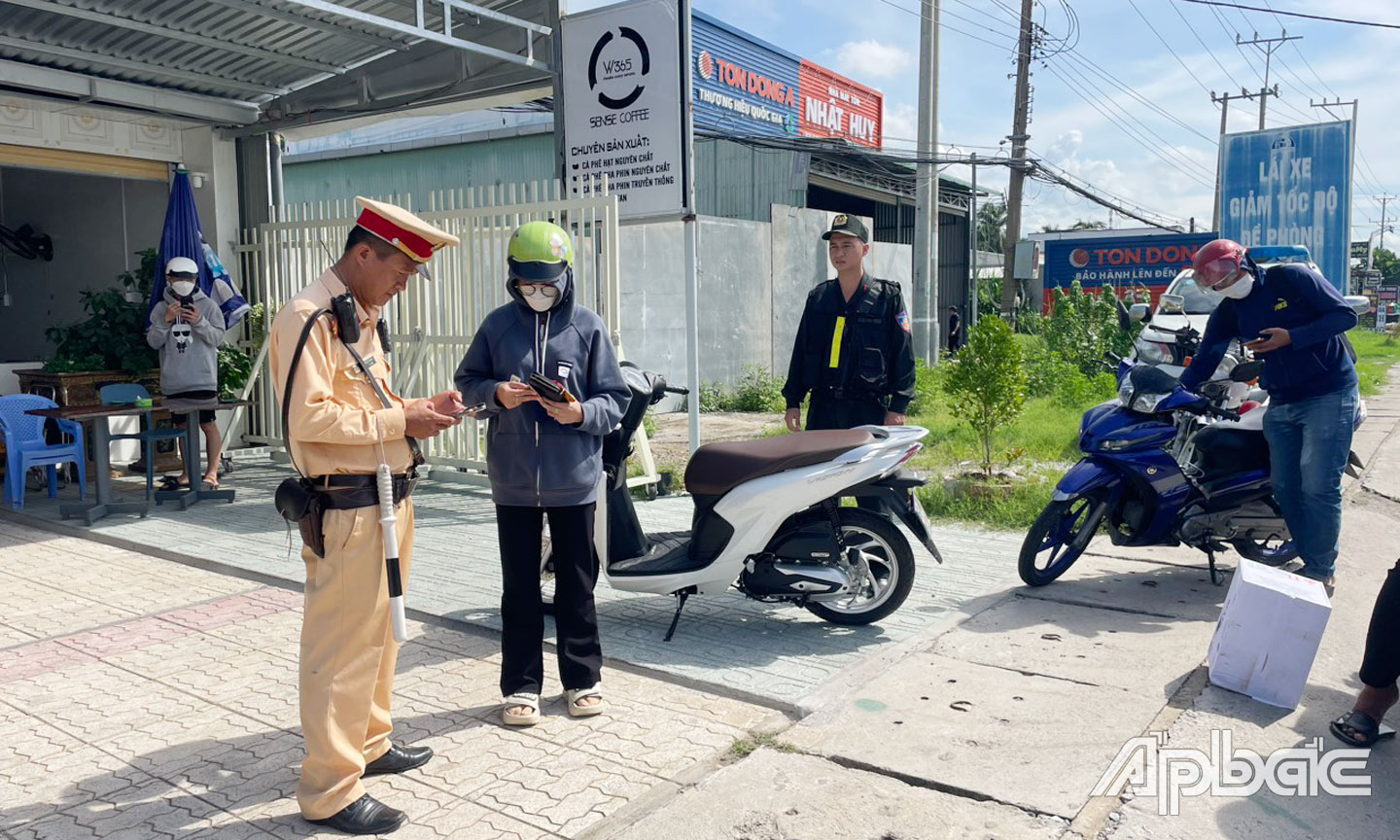 Lực lượng CSGT Công an tỉnh Tiền Giang kiểm tra, kiểm soát phương tiện qua tài khoản định danh điện tử VNeID. Ảnh: Anh Tuấn