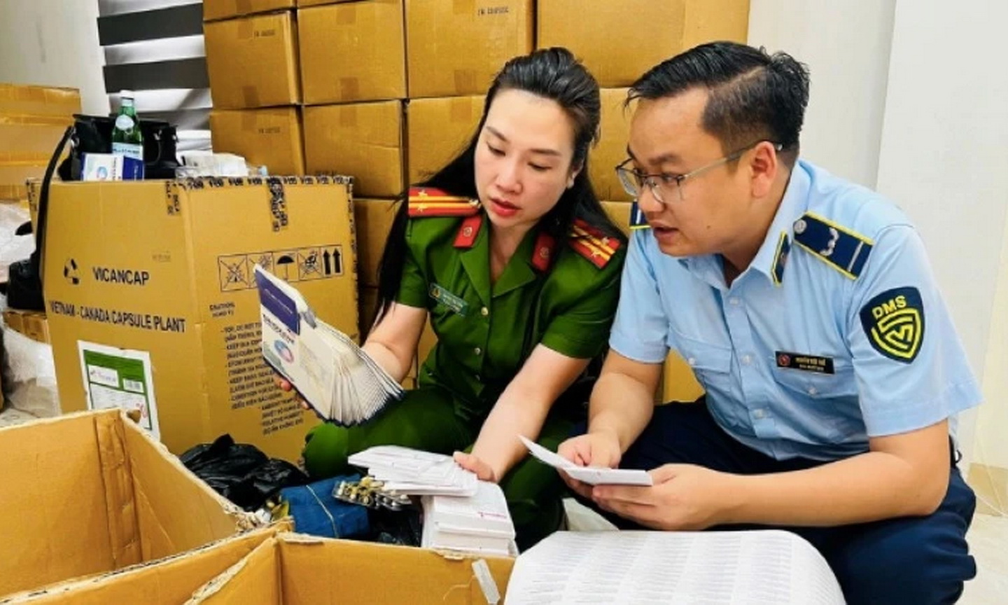 Cơ quan chức năng khám xét trụ sở một công ty sản xuất và buôn bán hàng giả quy mô lớn, thu giữ khoảng 100 tấn thực phẩm chức năng và trang thiết bị y tế giả. (Ảnh: Công an Hà Nội)